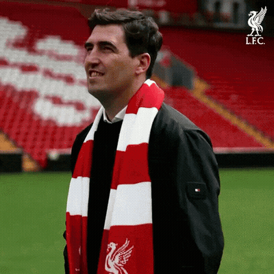 Man In Red And White Scarf With Liverpool Logo GIF