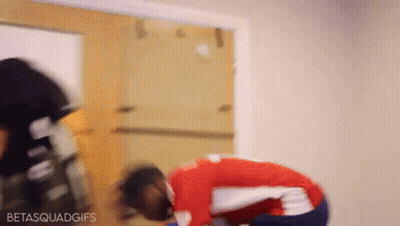 Man In Red And White Shirt Kneeling Before Door GIF