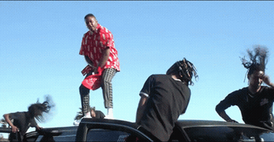 Man In Red And White Shirt Standing On Car GIF