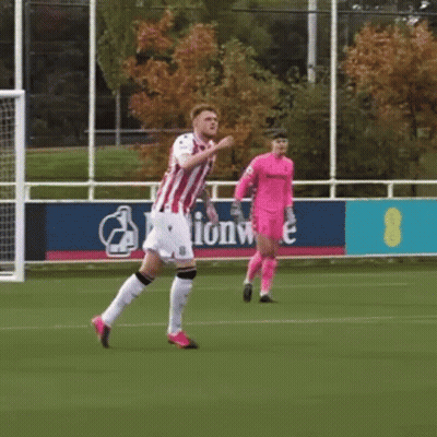 Man In Red And White Striped Shirt Running On Soccer Field GIF