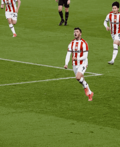 Man In Red And White Striped Shirt Running On Soccer Field GIF