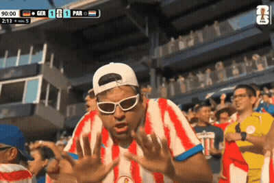 Man In Red And White Striped Shirt Watching GER Vs PAR Soccer GIF