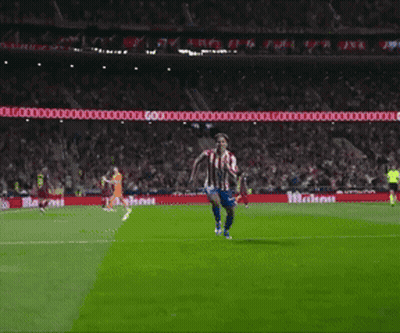 Man In Red And White Striped Shirt With Letter S Kneeling On Soccer Field GIF