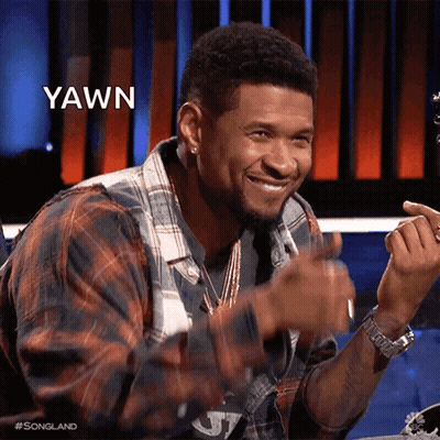 Man In Red And White Sweater Smiling At Table GIF