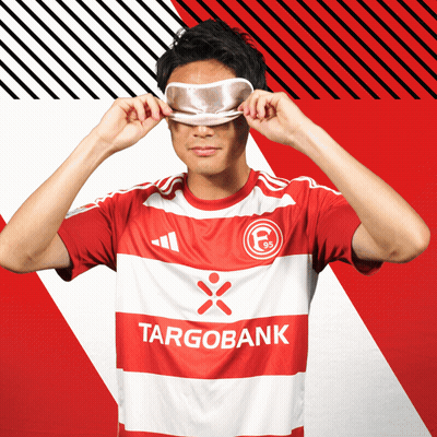 Man in Red and White Targobank Shirt