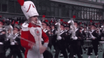 Man In Red And White Uniform Leading Band GIF