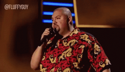 Man In Red And Yellow Shirt Holding Microphone GIF