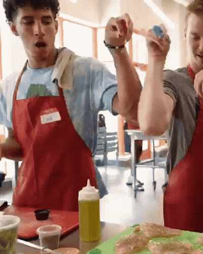Man In Red Apron With Name Tag Spencer GIF