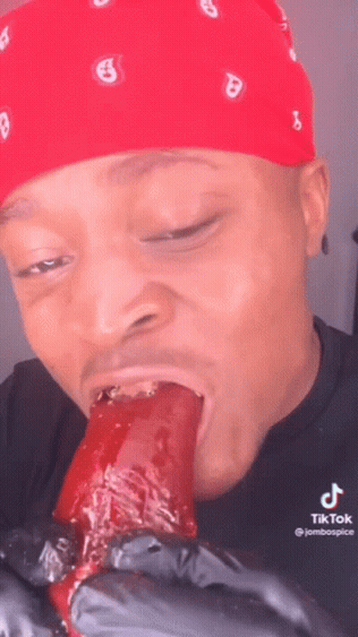 Man In Red Bandana Eating Long Food GIF