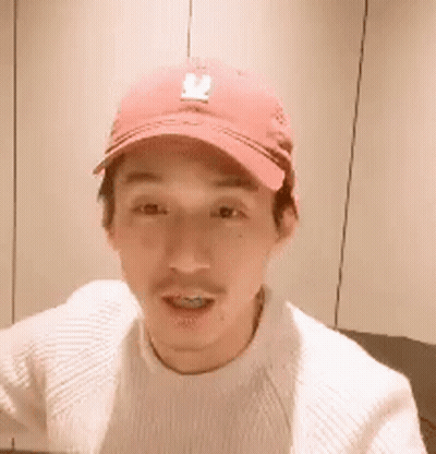 Man In Red Baseball Cap And White Sweater Smiling GIF
