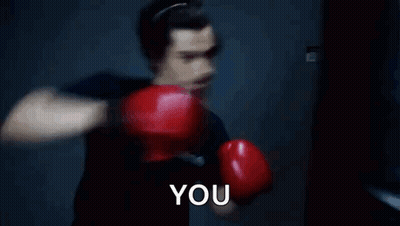 Man In Red Boxing Gloves Punching Bag Saying You GIF