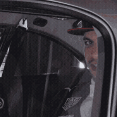 Man In Red Bull Hat Sitting In Car GIF