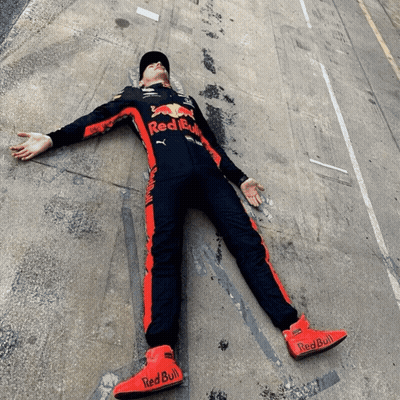 Man In Red Bull Outfit Lying With Arms Outstretched GIF