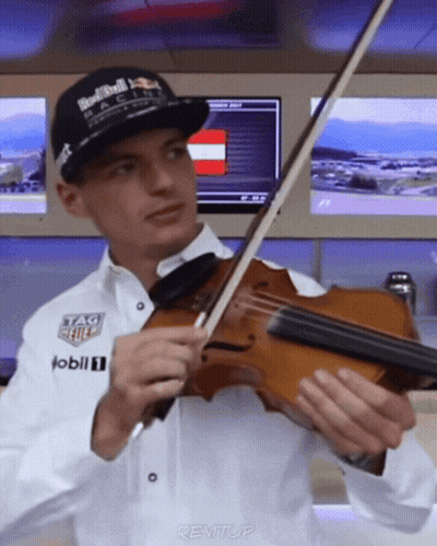 Man In Red Bull Racing Hat Playing Violin GIF