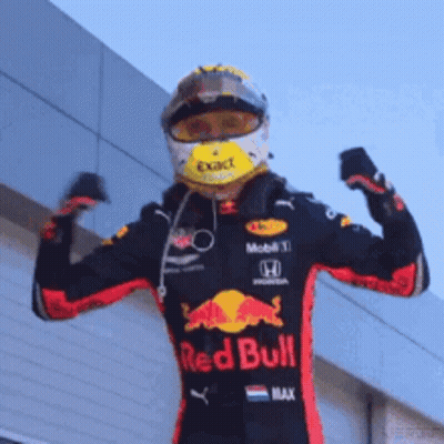 Man In Red Bull Racing Suit Flexing Muscles GIF