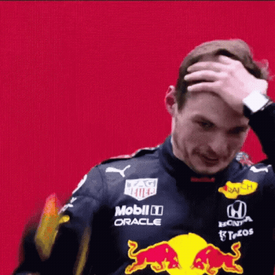 Man In Red Bull Racing Suit Scratching Head GIF
