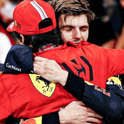 Man In Red Bull Shirt Hugging Man In CarNext Hat GIF