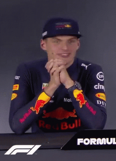 Man In Red Bull Shirt Sitting At Table GIF