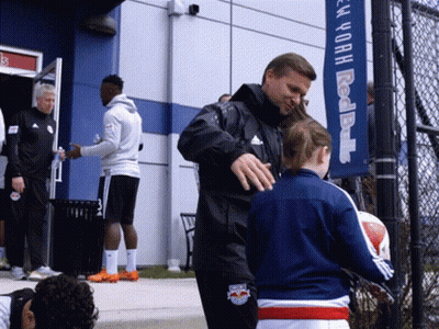 Man In Red Bulls Jacket Talking To Girl GIF