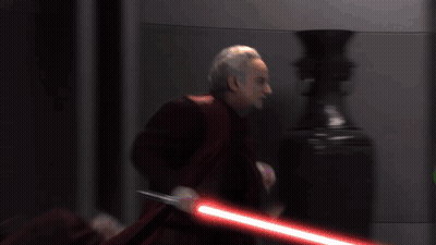 Man In Red Cape Holding Lightsaber GIF