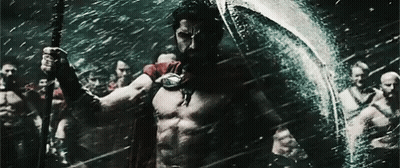 Man In Red Cape Holding Spear And Shield GIF