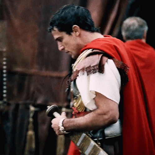 Man In Red Cape Holding Sword GIF