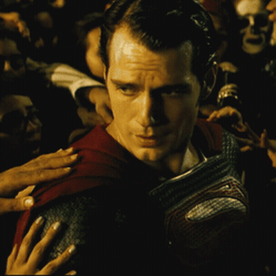Man In Red Cape Surrounded By Crowd GIF