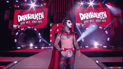 Man In Red Cape Walking Stage Danhausen Banner GIF