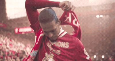 Man In Red Champions Shirt Holding Scarf GIF
