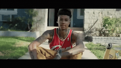 Man In Red Cleveland Jersey Sitting On Sidewalk GIF