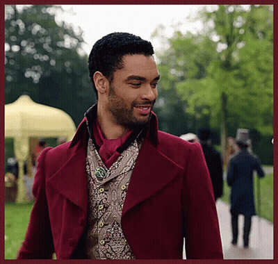 Man In Red Coat And Vest Walking Down Path GIF