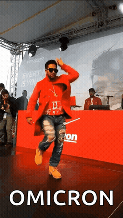 Man In Red Coat Dancing In Front Of Verizon Banner GIF