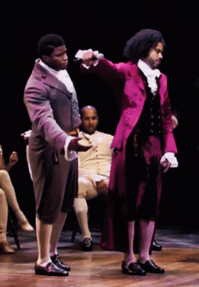 Man In Red Coat Holding Microphone GIF