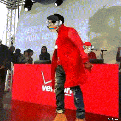 Man In Red Coat In Front Of Red Verizon Sign GIF