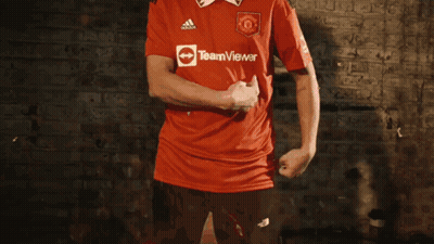 Man In Red Coat Running With Bucket On Back GIF