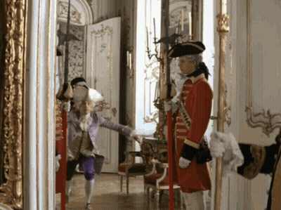 Man In Red Coat Standing In Hallway GIF