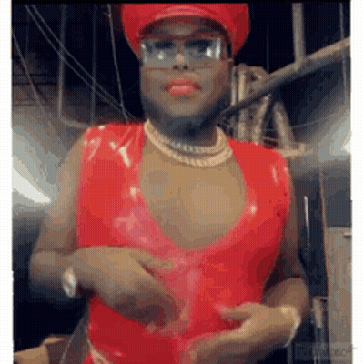Man In Red Dress And Hat With Necklace And Sunglasses GIF