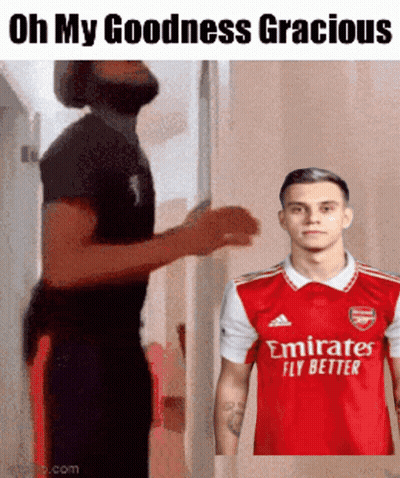 Man In Red Emirates Fly Better Shirt Next To Another Man GIF
