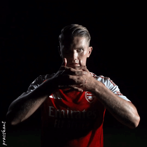 Man In Red Emirates Jersey Holding Hands GIF