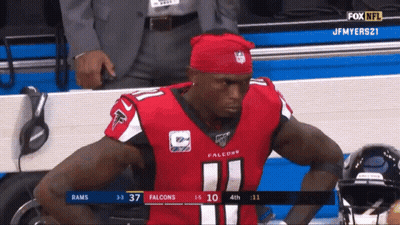 Man In Red Falcons Jersey Sitting In Stands GIF