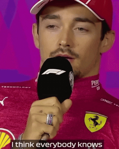 Man In Red Ferrari Shirt Holding Microphone GIF