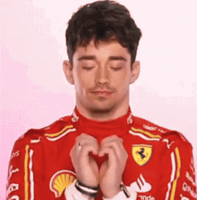 Man In Red Ferrari Suit Making Heart GIF