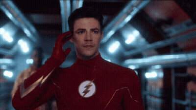 Man In Red Flash Suit Talking On Phone GIF