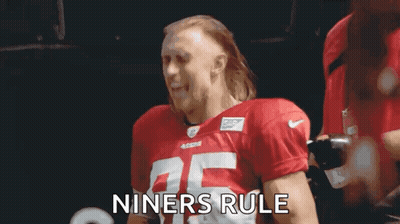 Man in Red Football Jersey Holding Chest