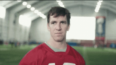 Man In Red Football Jersey Looking At Camera GIF
