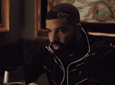 Man In Red Fur Coat Sitting In Stadium GIF