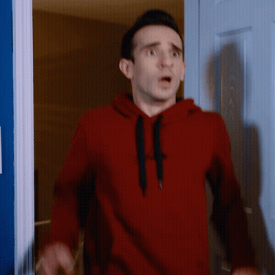 Man In Red Gap Hoodie Standing In Front Of Door GIF