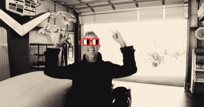 Man In Red Glasses Sitting In Garage GIF