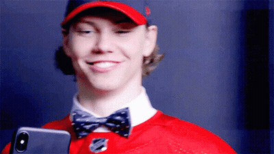 Man In Red Hat And Bow Tie Holding Phone GIF