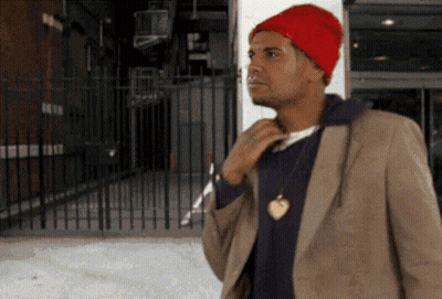 Man In Red Hat And Brown Jacket At Fence GIF